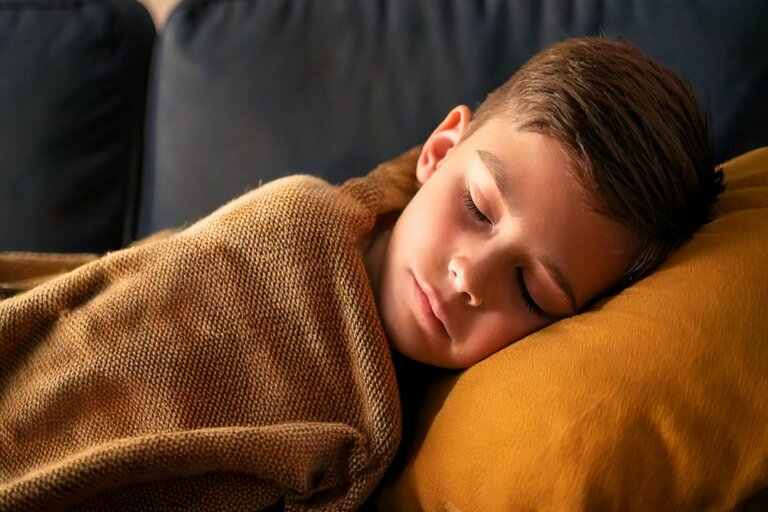 Teenager girl sleeping in her bed