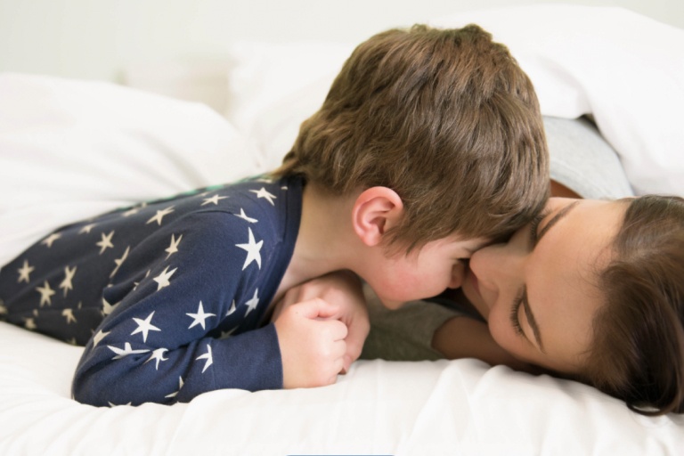 Mother and Son in Pajamas laying in bed